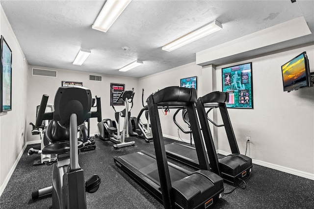 gym with a textured ceiling