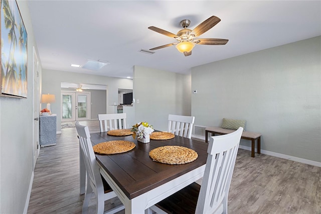 dining area with hardwood / wood-style flooring and ceiling fan