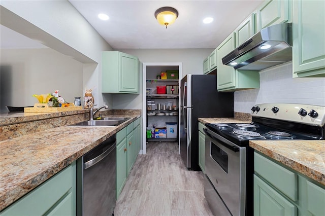 kitchen featuring sink, stainless steel appliances, and green cabinets