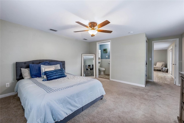 carpeted bedroom with ceiling fan and ensuite bath