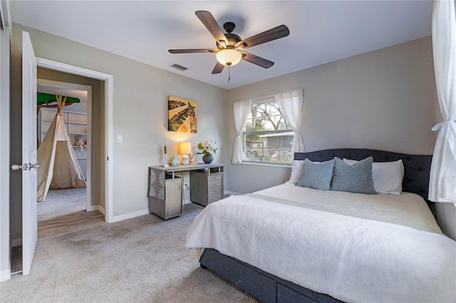 bedroom featuring ceiling fan and light carpet