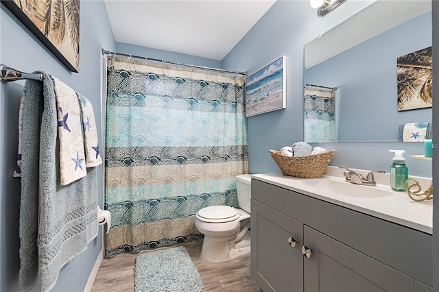 bathroom with vanity, wood-type flooring, toilet, and walk in shower