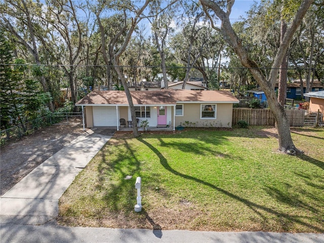 ranch-style house featuring a garage and a front yard