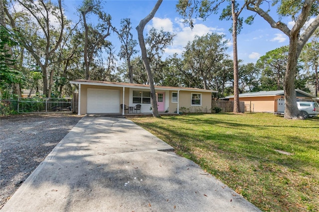 ranch-style home featuring a garage and a front lawn