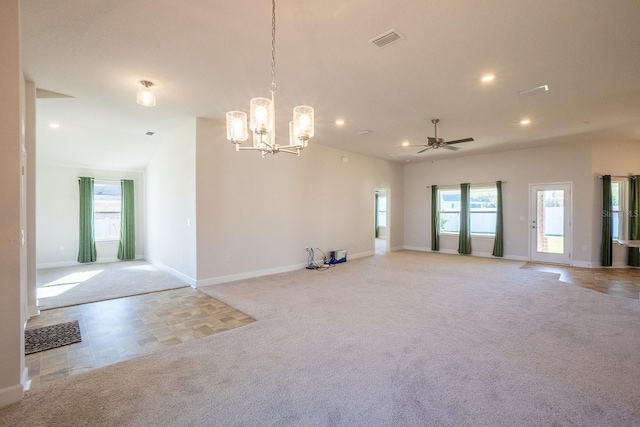 empty room with carpet floors, recessed lighting, visible vents, baseboards, and ceiling fan with notable chandelier