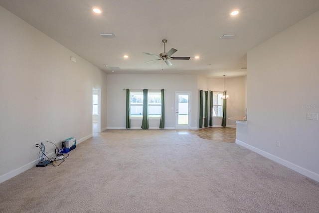 carpeted spare room featuring ceiling fan, visible vents, baseboards, and recessed lighting