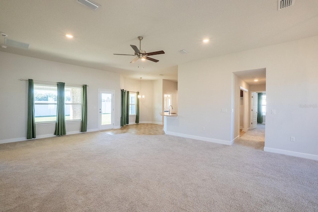 empty room with ceiling fan, visible vents, and light colored carpet