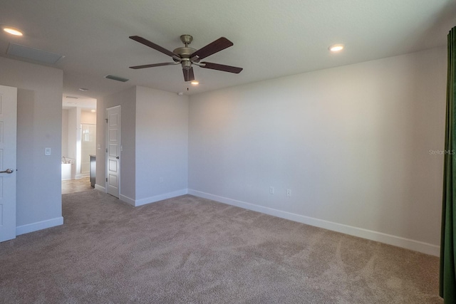 carpeted spare room with baseboards, visible vents, and recessed lighting