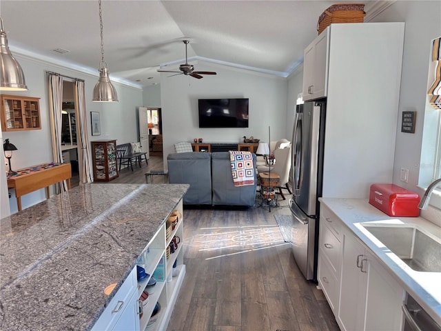 kitchen featuring white cabinetry, lofted ceiling, appliances with stainless steel finishes, and a sink