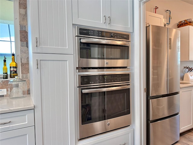 kitchen with stainless steel appliances and white cabinetry