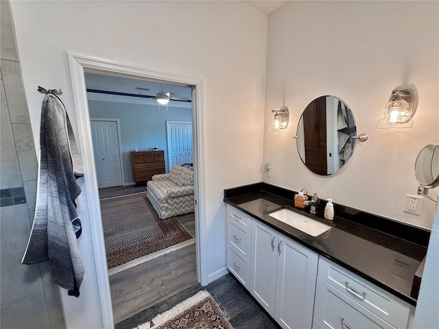 bathroom featuring ensuite bath, vanity, and wood finished floors