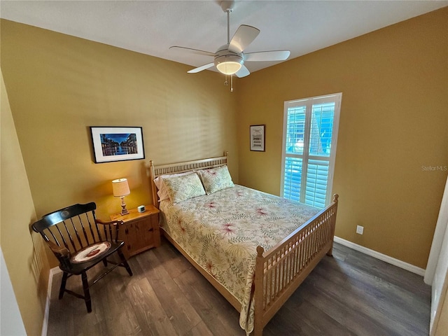 bedroom featuring a ceiling fan, wood finished floors, and baseboards