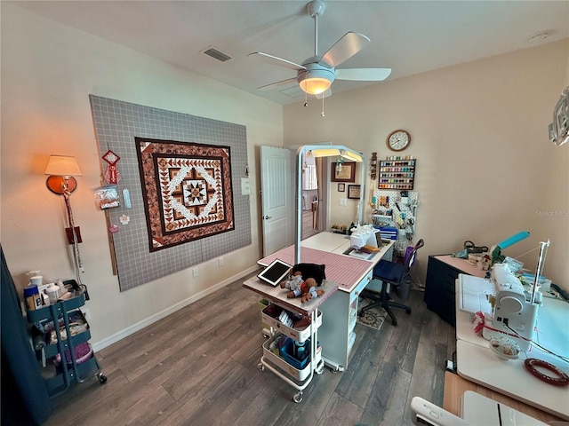 office space with dark wood finished floors, visible vents, ceiling fan, and baseboards