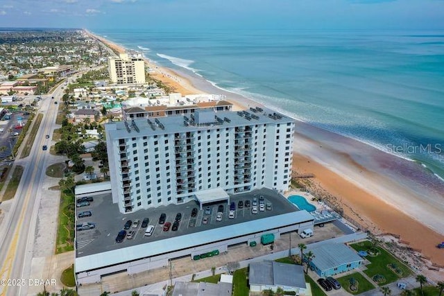 bird's eye view featuring a water view and a beach view