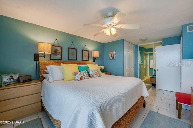 tiled bedroom with ceiling fan and a closet