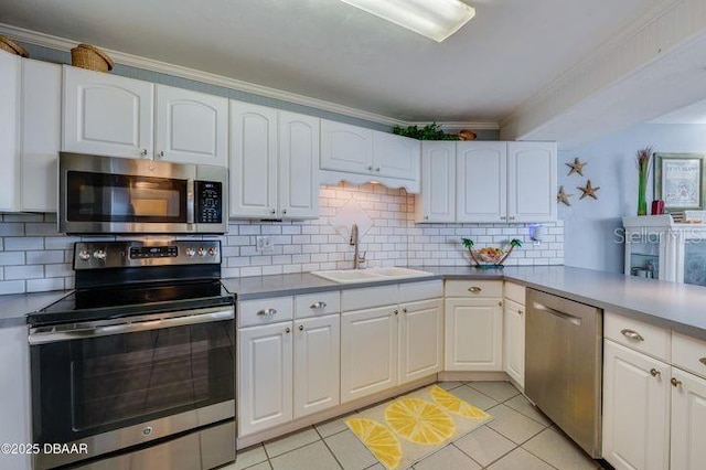 kitchen featuring light tile patterned floors, stainless steel appliances, sink, and white cabinets