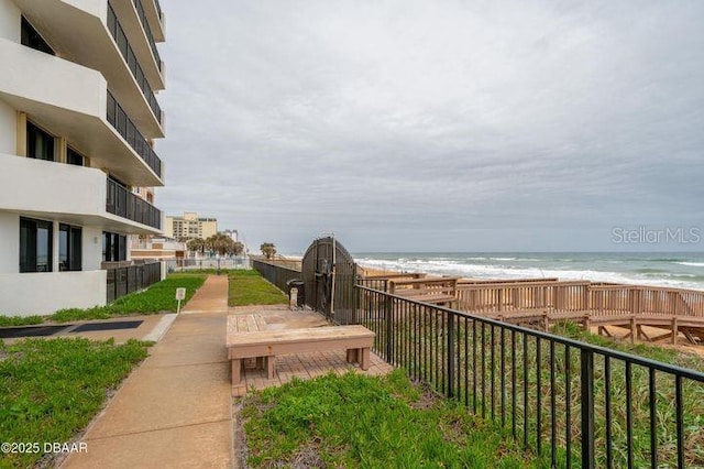 surrounding community with a view of the beach and a water view