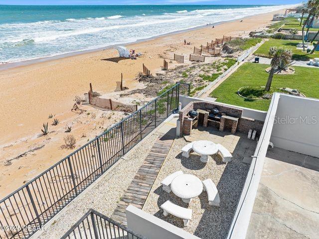 exterior space featuring a water view and a beach view