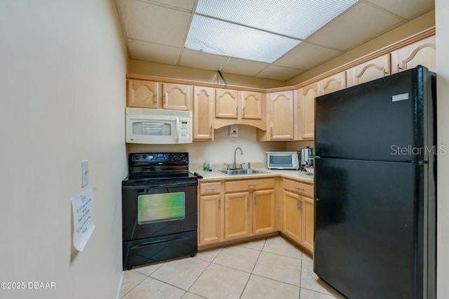 kitchen featuring light tile patterned floors, light brown cabinetry, sink, and black appliances