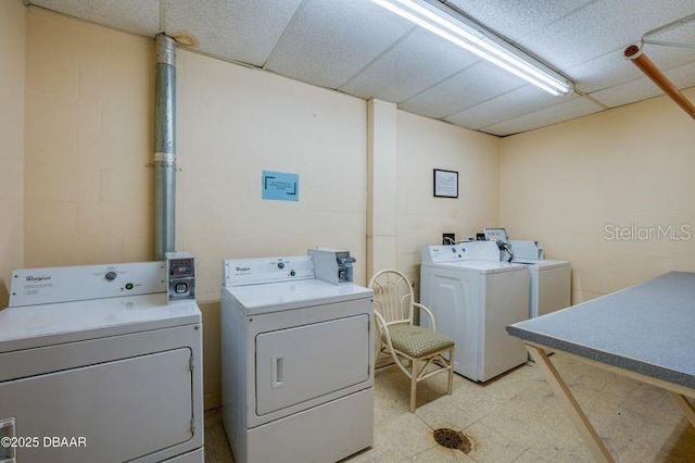 clothes washing area with washing machine and dryer