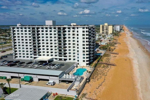 drone / aerial view with a beach view and a water view