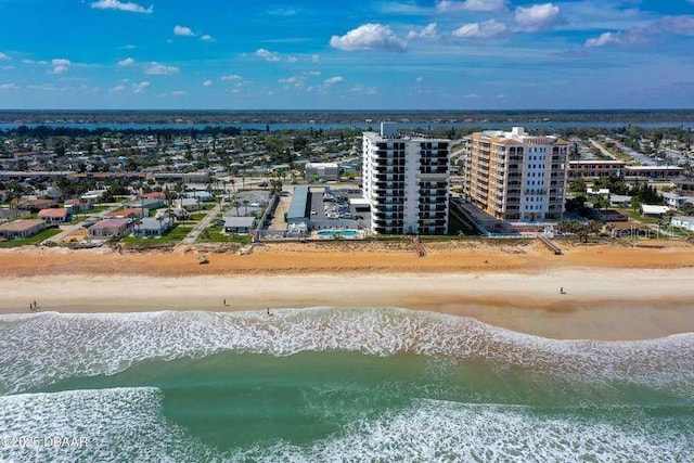 bird's eye view featuring a water view and a beach view