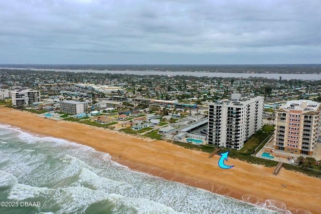 bird's eye view featuring a water view and a beach view