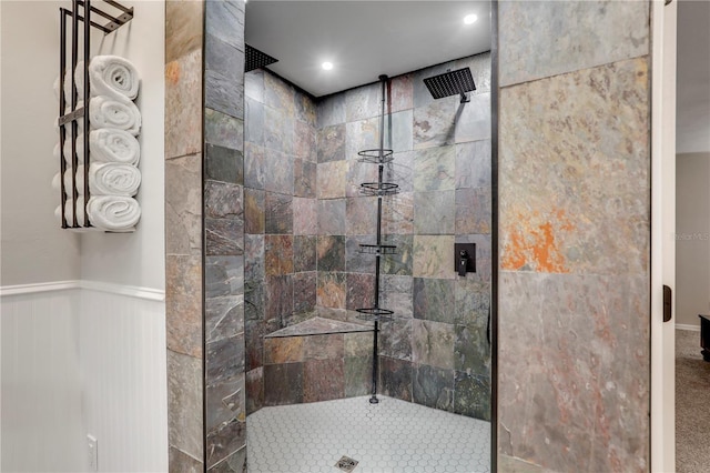 bathroom featuring a wainscoted wall, a walk in shower, and recessed lighting