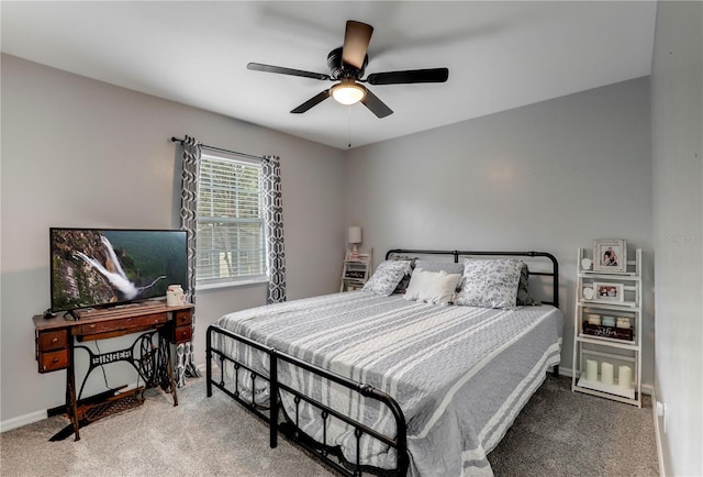 carpeted bedroom featuring ceiling fan and baseboards