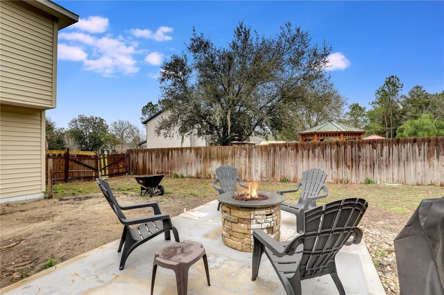 view of patio / terrace with a gazebo, an outdoor fire pit, and a fenced backyard