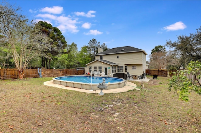 view of swimming pool featuring a fenced in pool, a fenced backyard, and a yard