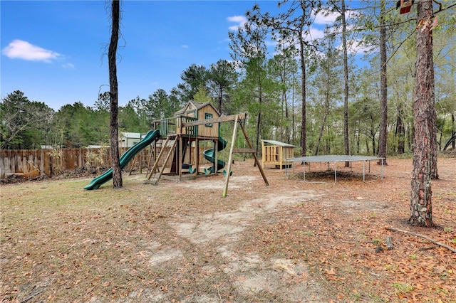 view of jungle gym with a trampoline and fence