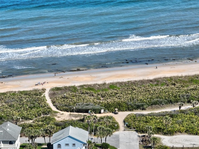 drone / aerial view featuring a water view and a beach view