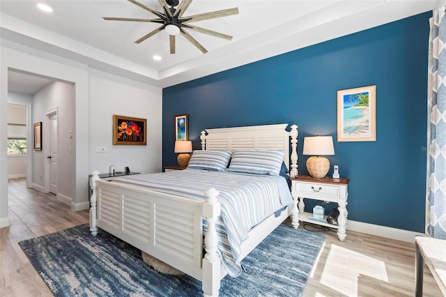 bedroom featuring ceiling fan, baseboards, wood finished floors, and recessed lighting