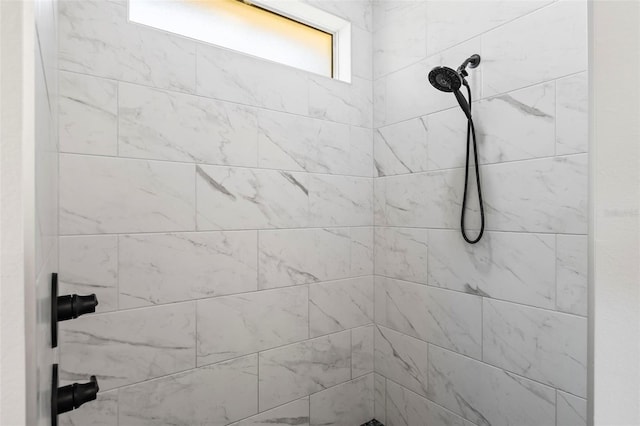 bathroom with a tile shower