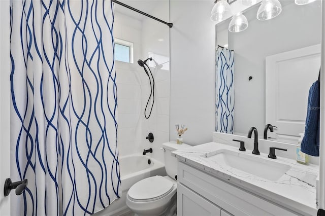 bathroom featuring vanity, shower / bath combo with shower curtain, and toilet