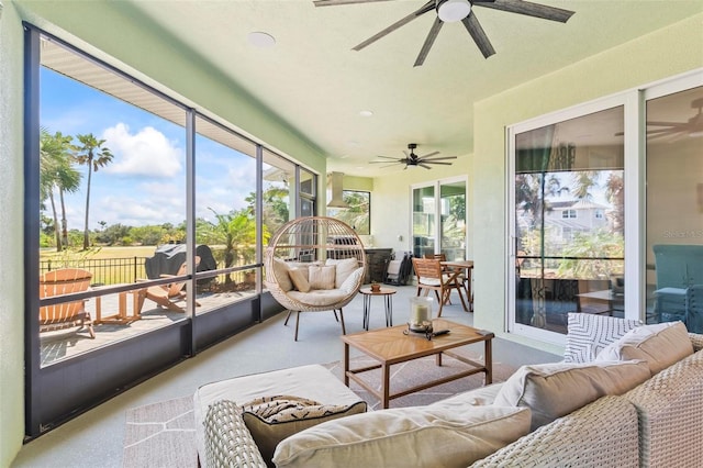 sunroom / solarium with plenty of natural light and a ceiling fan