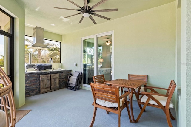 sunroom featuring ceiling fan