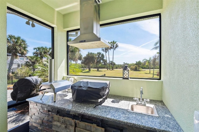 view of patio featuring a sink, grilling area, an outdoor kitchen, and fence