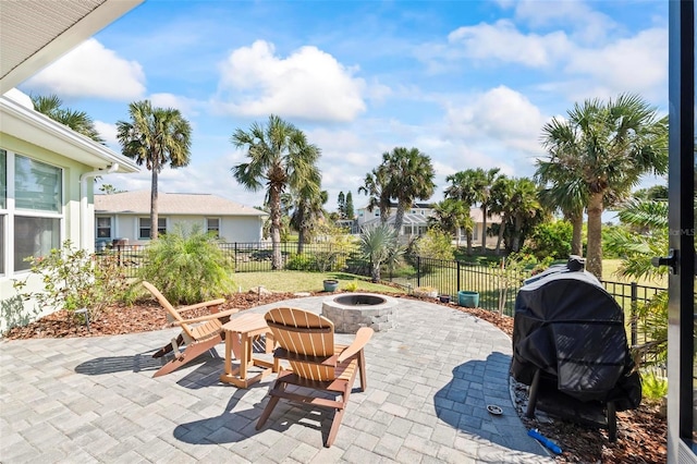 view of patio with a fenced backyard, a grill, and a fire pit