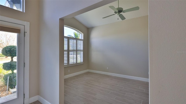 foyer entrance with light wood-type flooring, vaulted ceiling, and ceiling fan