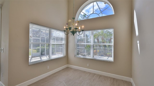 unfurnished dining area featuring a notable chandelier and light hardwood / wood-style floors