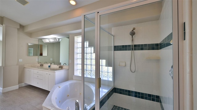 bathroom with shower with separate bathtub and vanity