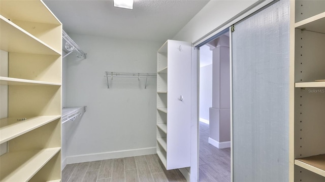 spacious closet featuring hardwood / wood-style flooring