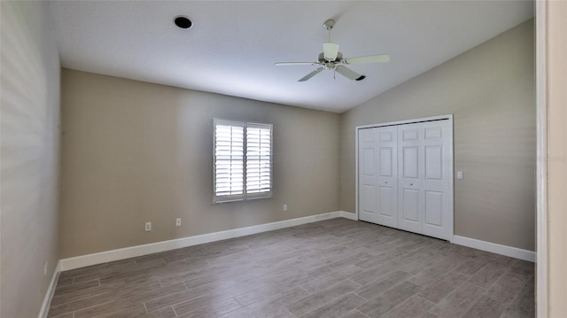 unfurnished bedroom with ceiling fan, a closet, vaulted ceiling, and light hardwood / wood-style floors