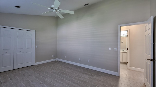 unfurnished bedroom featuring ceiling fan, a closet, and light hardwood / wood-style floors