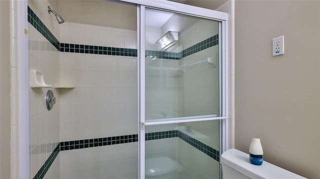 bathroom with toilet and walk in shower