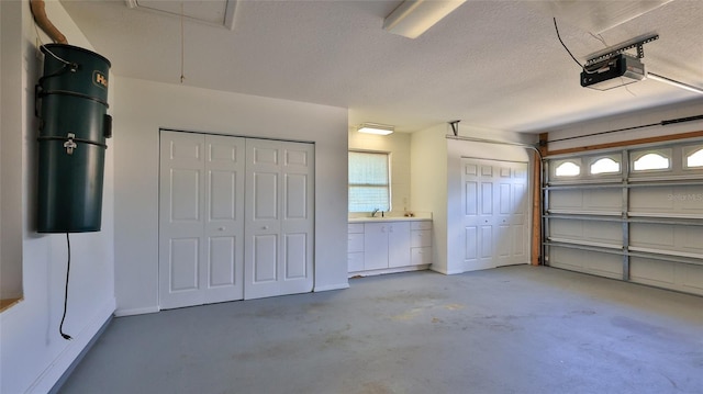 garage featuring sink and a garage door opener