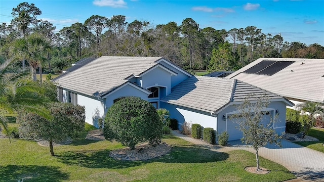 single story home featuring a front lawn and a garage