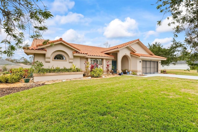 mediterranean / spanish house featuring concrete driveway, a tiled roof, an attached garage, a front lawn, and stucco siding